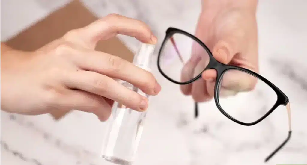 Spraying lenses with eyeglass cleaning solution